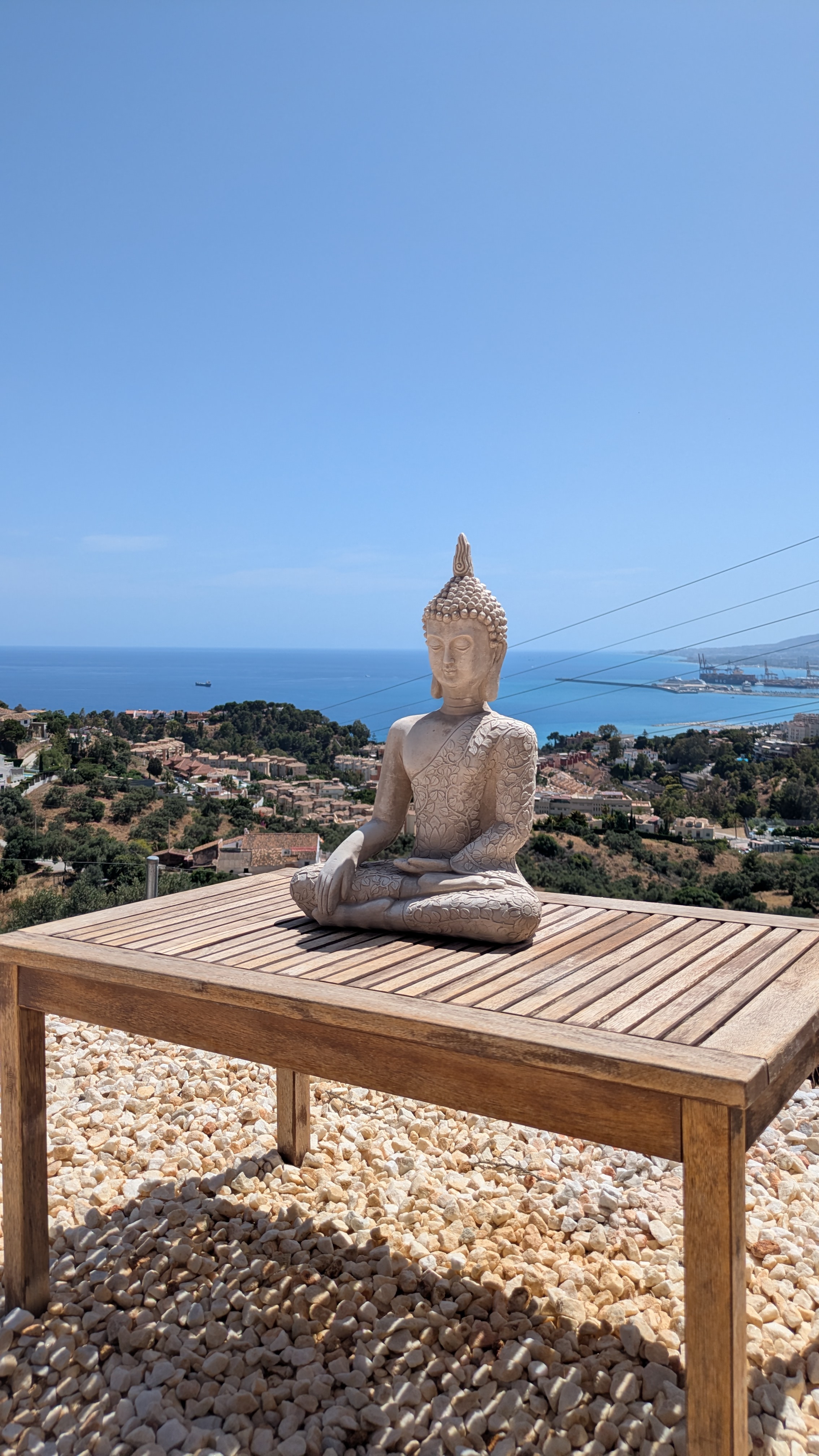 Buddha statue with Málaga sea view