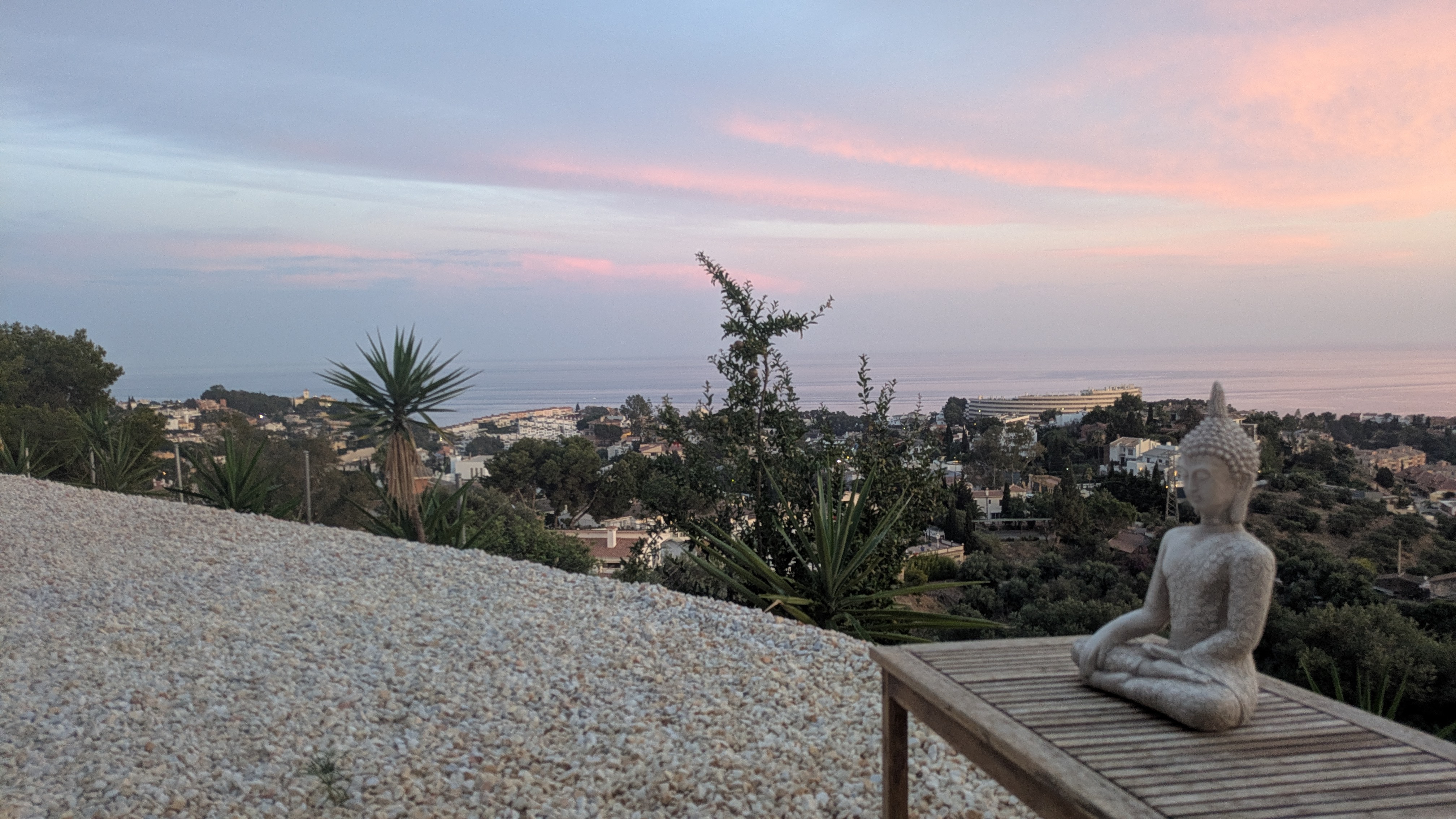 Friends enjoying a private sunset yoga event on a sea-view deck in Málaga